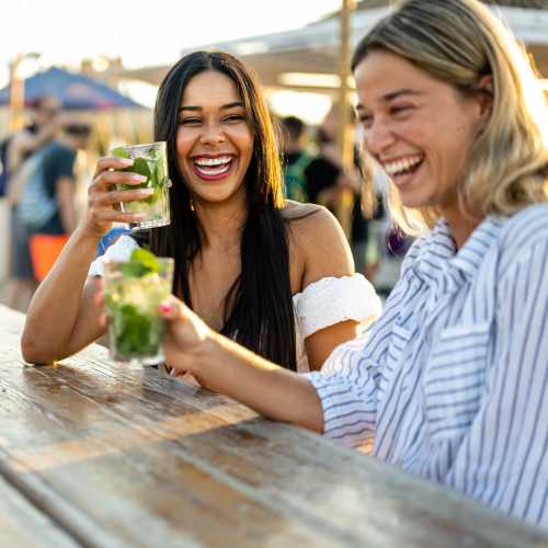 Resident friends enjoying drinks outside on a beautiful day at The Overlook at Keystone Canyon in Reno, Nevada