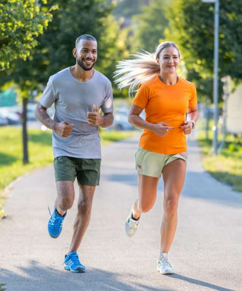 Resident couple jogging at a park near Ludlam Point in Miami, Florida