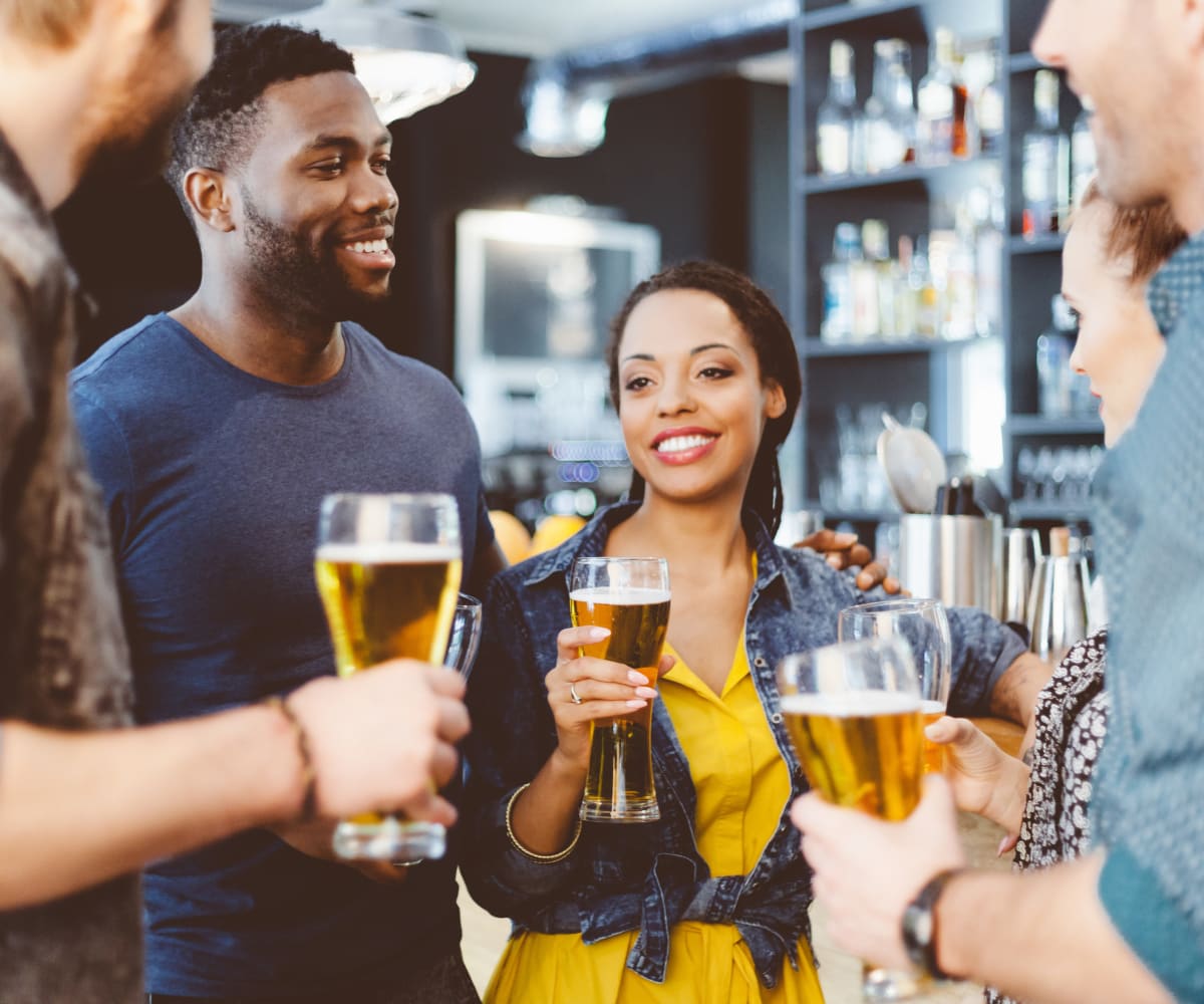 Friends enjoying beverages at Acacia Park Apartments in El Paso, Texas