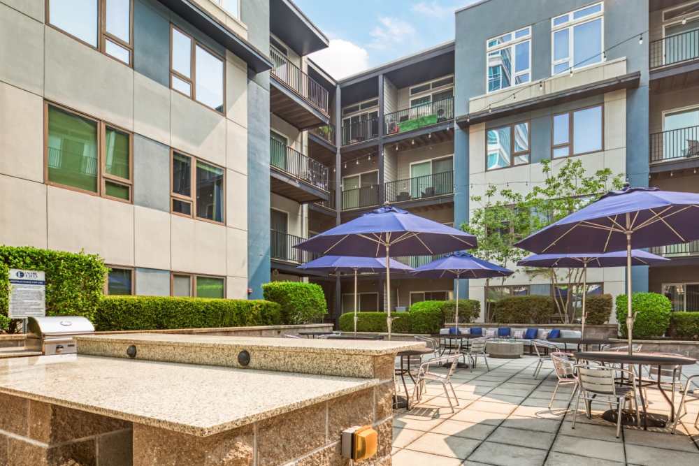 Fire pit surrounded by seating and tables at The Residences at Town Center in Virginia Beach, Virginia