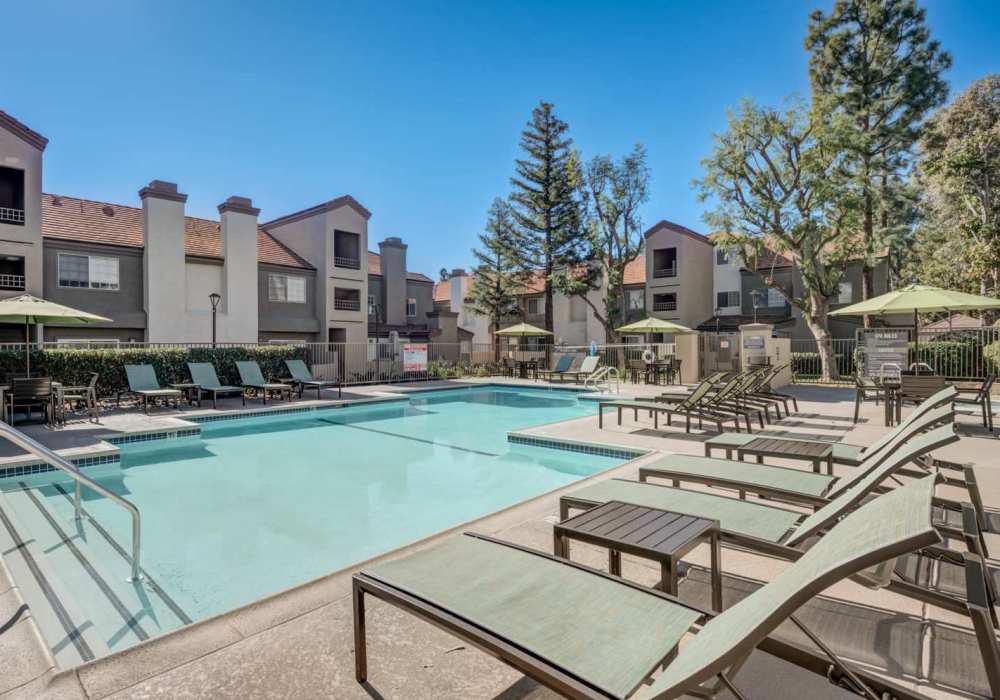 Swimming pool with lounge chairs at The Bluffs in Rancho Cucamonga, California