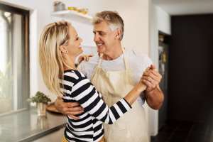 woman and man dancing in the kitchen