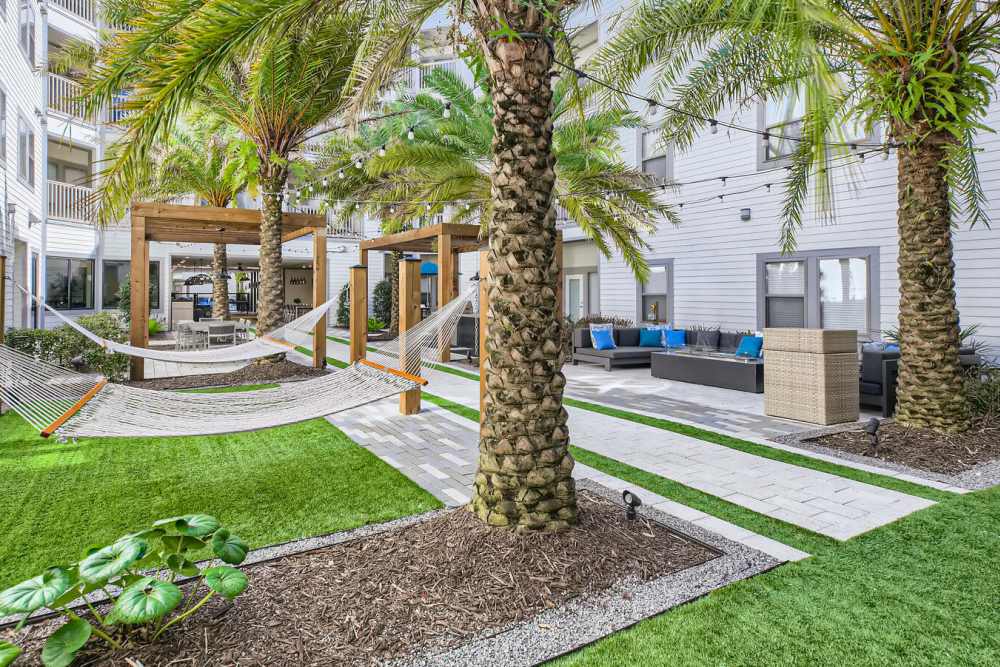 Outdoor courtyard with hammocks at Soba Apartments in Jacksonville, Florida