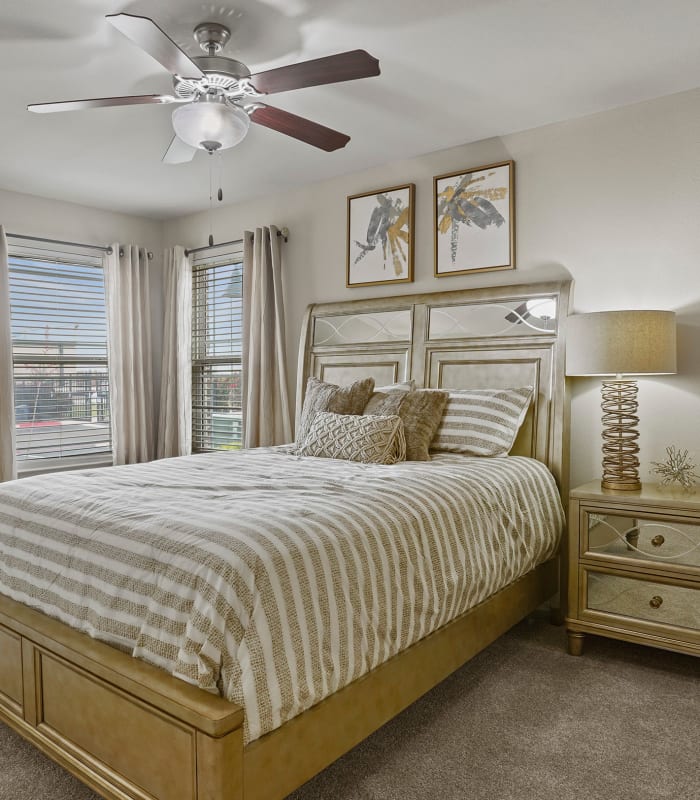 Spacious carpeted bedroom at Cottages at Abbey Glen Apartments in Lubbock, Texas