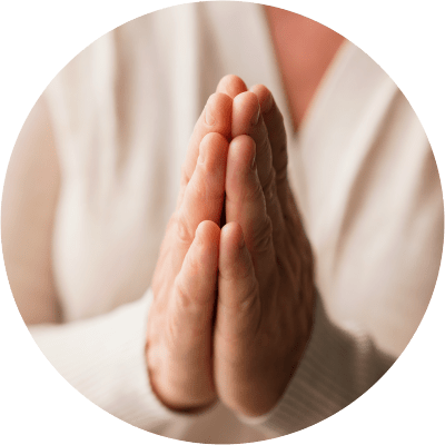resident sitting with their hands folded in prayer at The Spring at Silverton in Fort Worth, Texas