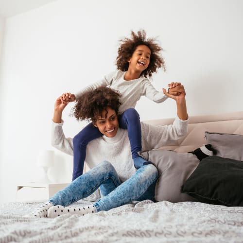 A mother and daughter in a bedroom at Orleck Heights in San Diego, California