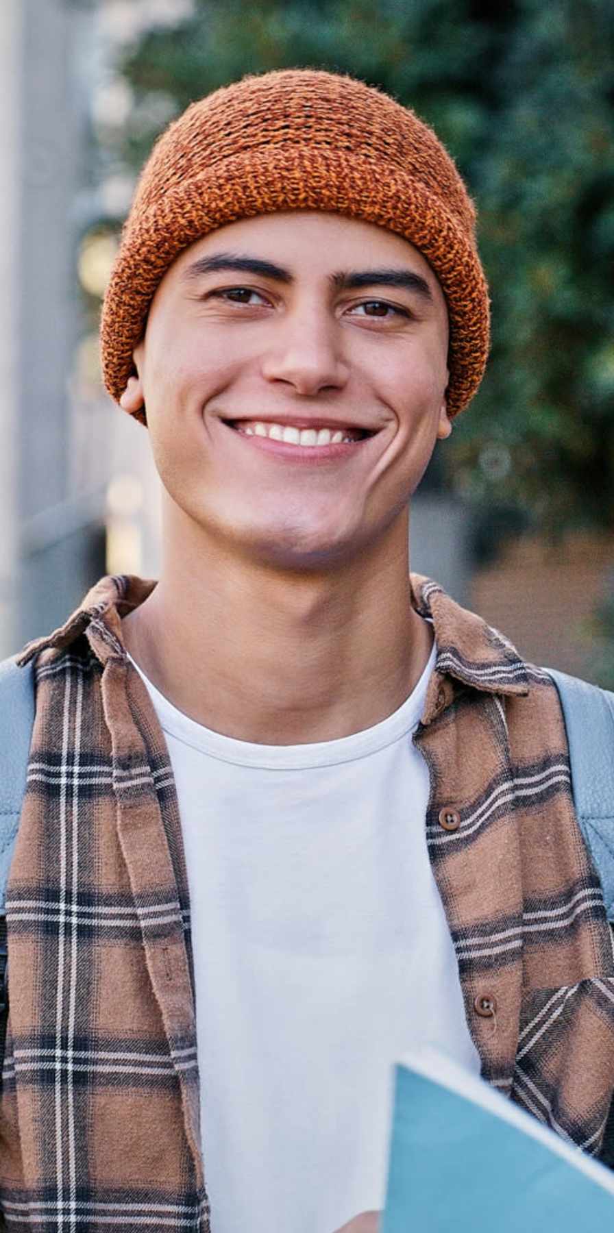 Student posing for a photo with book in hand at Mazza Grandmarc in College Park, Maryland