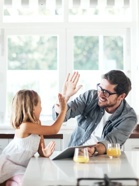 Resident and child high five their new kitchen at Lupine at Longmont in Longmont, Colorado