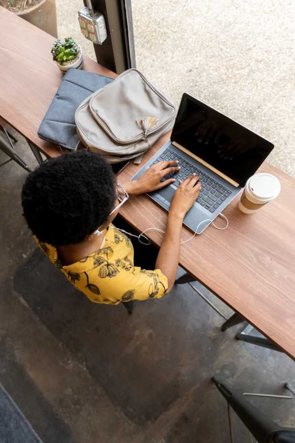 Resident working from a cafe near The Abbey at Hightower in North Richland Hills, Texas