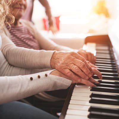 Resident giving a piano lesson at Westminster Memory Care in Lexington, South Carolina