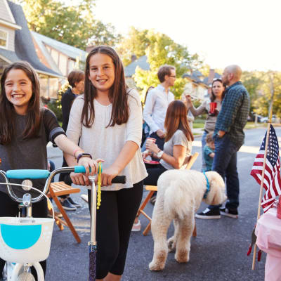 Kids riding on scooters and bikes at a neighborhood party at Stanley Court in Portsmouth, Virginia