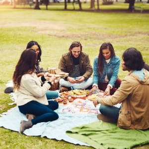 Residents and friends enjoying a picnic on the lawn at Lofts at Pecan Ridge in Midlothian, Texas