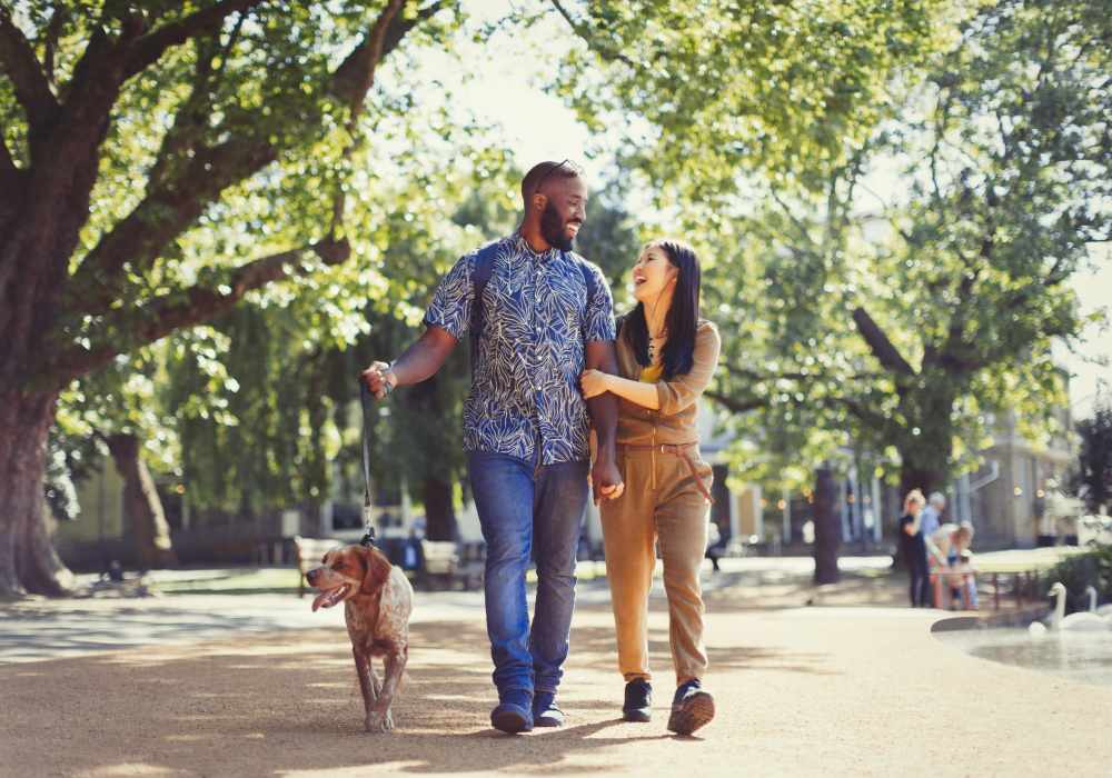 Resident couple walking their pup near their home at Nova at Biltmore Park in Arden, North Carolina