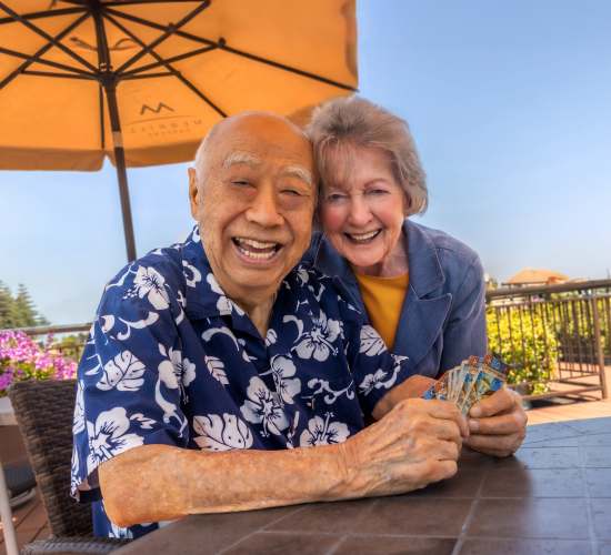 Resident couple poses for a picture at Merrill Gardens at Columbia in Columbia, South Carolina. 