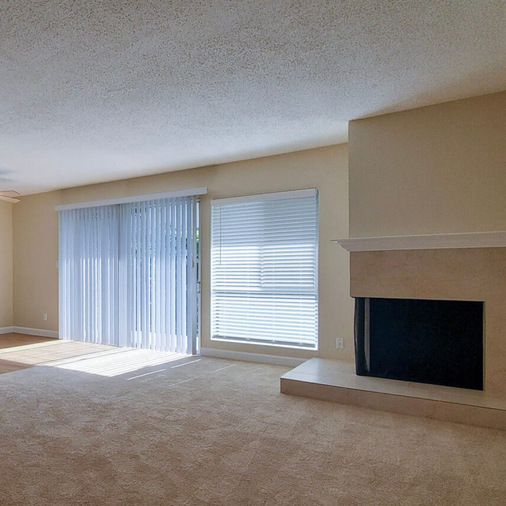 Fireplace and plush carpeting in a model apartment's living area at Mission Rock at San Rafael in San Rafael, California