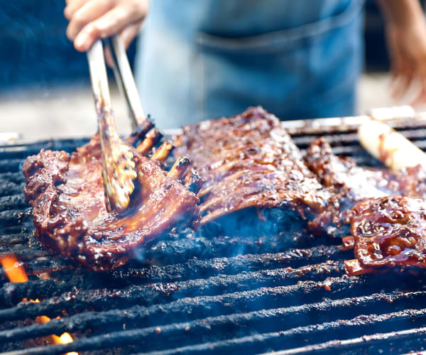 A resident barbequing food on a grill at Naval Amphibious Base in San Diego, California