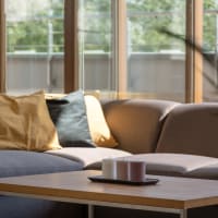 A furnished apartment living room with large windows at Astoria in Mobile, Alabama