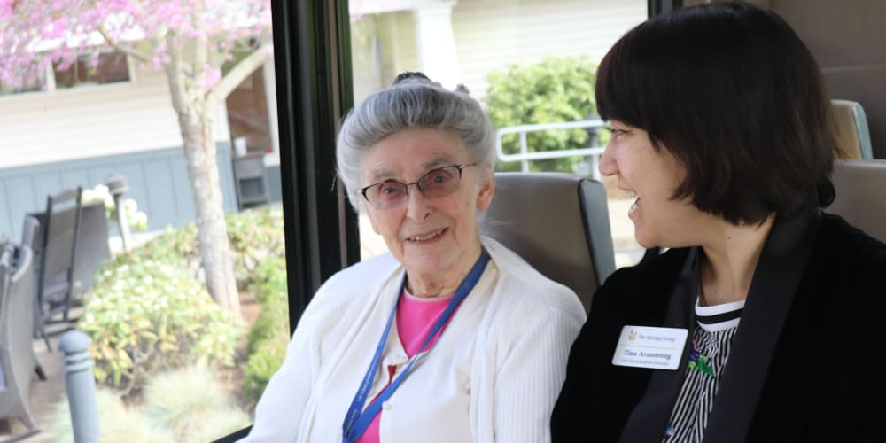 Resident chatting with caregiver while going on a day trip at The Springs at Sherwood in Sherwood, Oregon