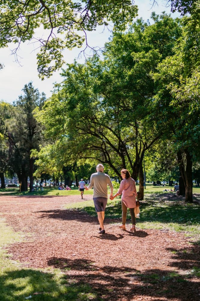 Couple walking in the park near Auburn Villas Senior Apartments in Auburn, California