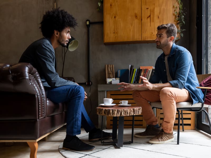 Two men sitting and talking in a coffee shop near Hunt Club in Gaithersburg, Maryland