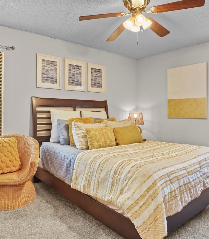 Chic bedroom with ceiling fan at Polo Run Apartments in Tulsa, Oklahoma
