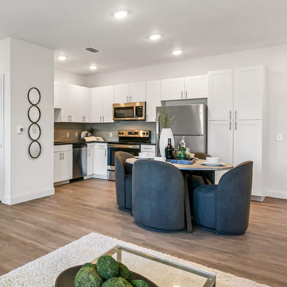 Wood-style flooring in an apartment living room and dining area at Grand Oak Apartments in Largo, Florida