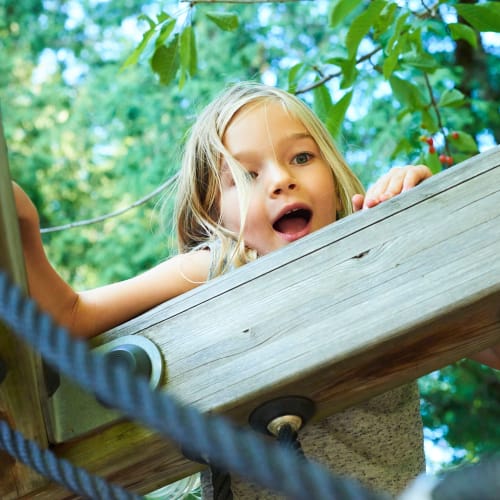 A kid playing at park near The Village at NTC in San Diego, California