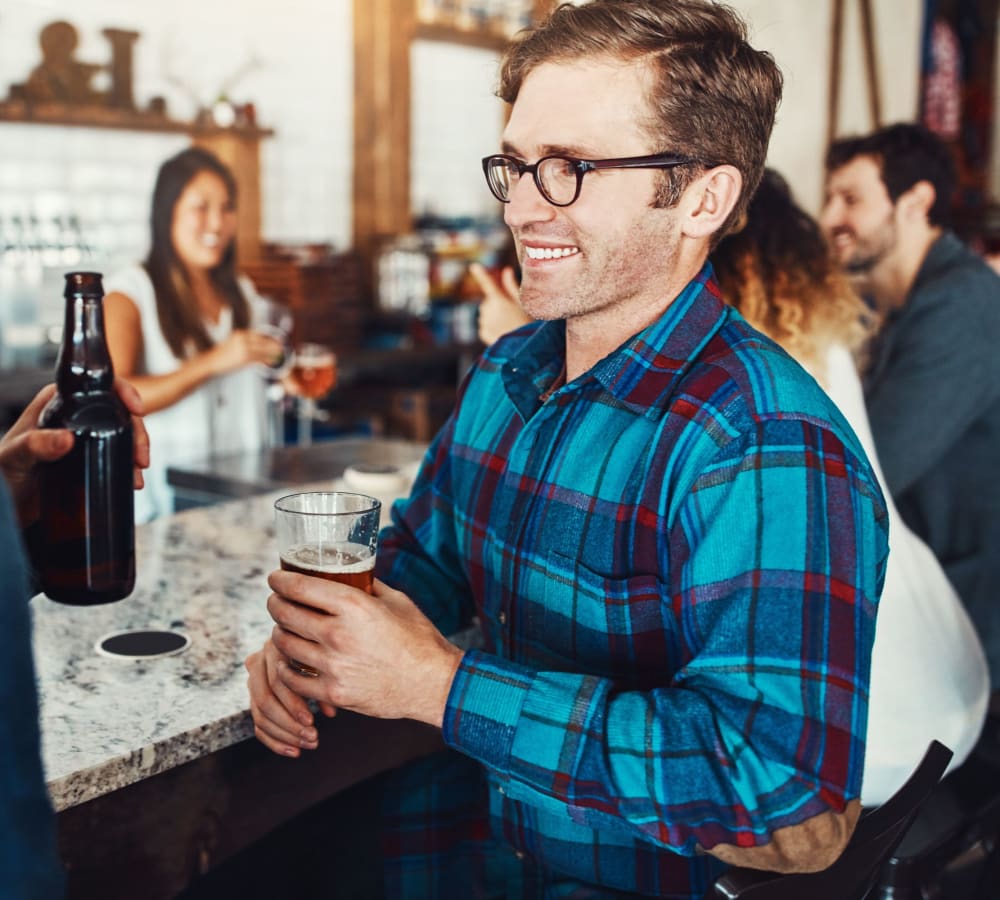 Resident enjoying a Northwest craft brew at his favorite watering hole near Avery at Orenco Station in Hillsboro, Oregon