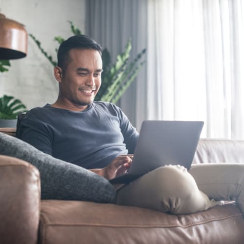 A resident using a computer in a home at Madigan in Joint Base Lewis McChord, Washington