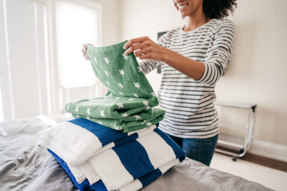 A resident folding laundry in her apartment at Santa Fe Apartment Homes in Dallas, Texas