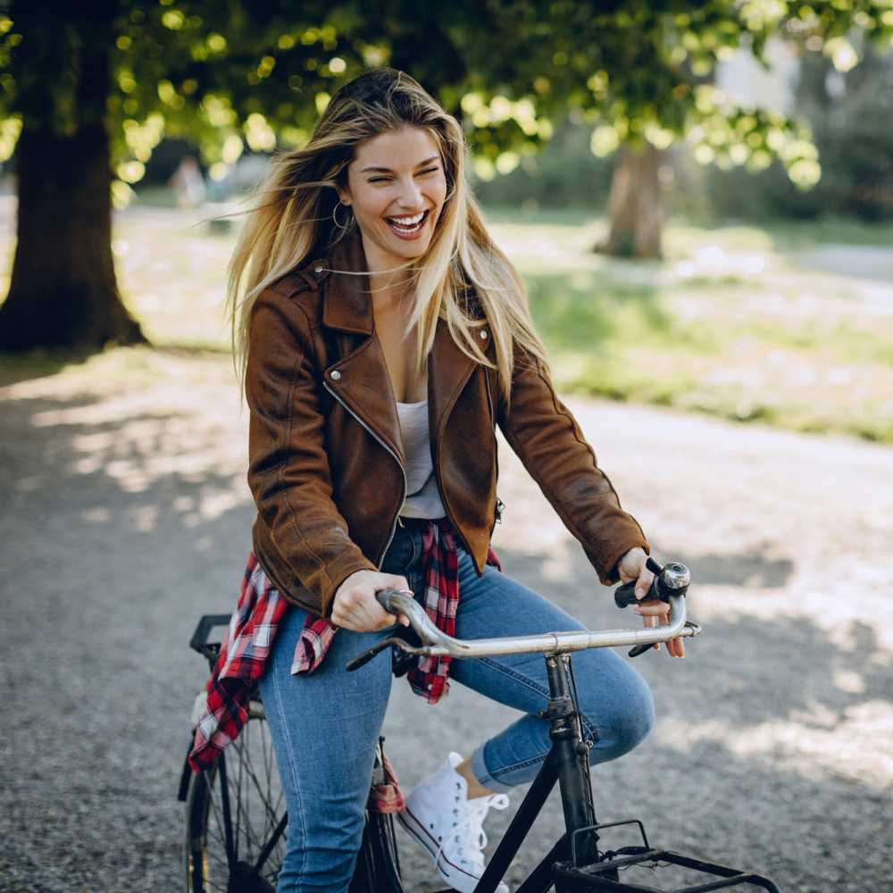 Resident riding a bicycle in the park near Old Hundred Trace Apartments in Midlothian, Virginia