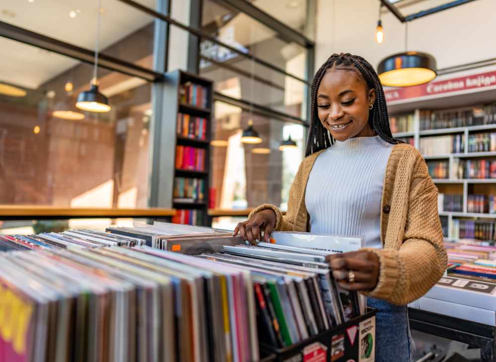 Resident woman searching for books in library near Ansley Murrayhill in Tigard, Oregon