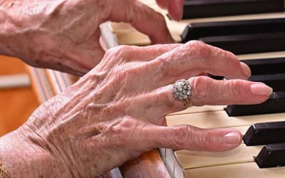 Resident playing piano at Mattison Crossing at Manalapan Avenue in Freehold, New Jersey