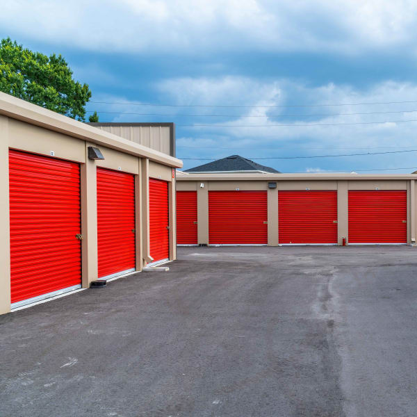 Outdoor storage units with red doors at StorQuest Express Self Service Storage in Copperopolis, California