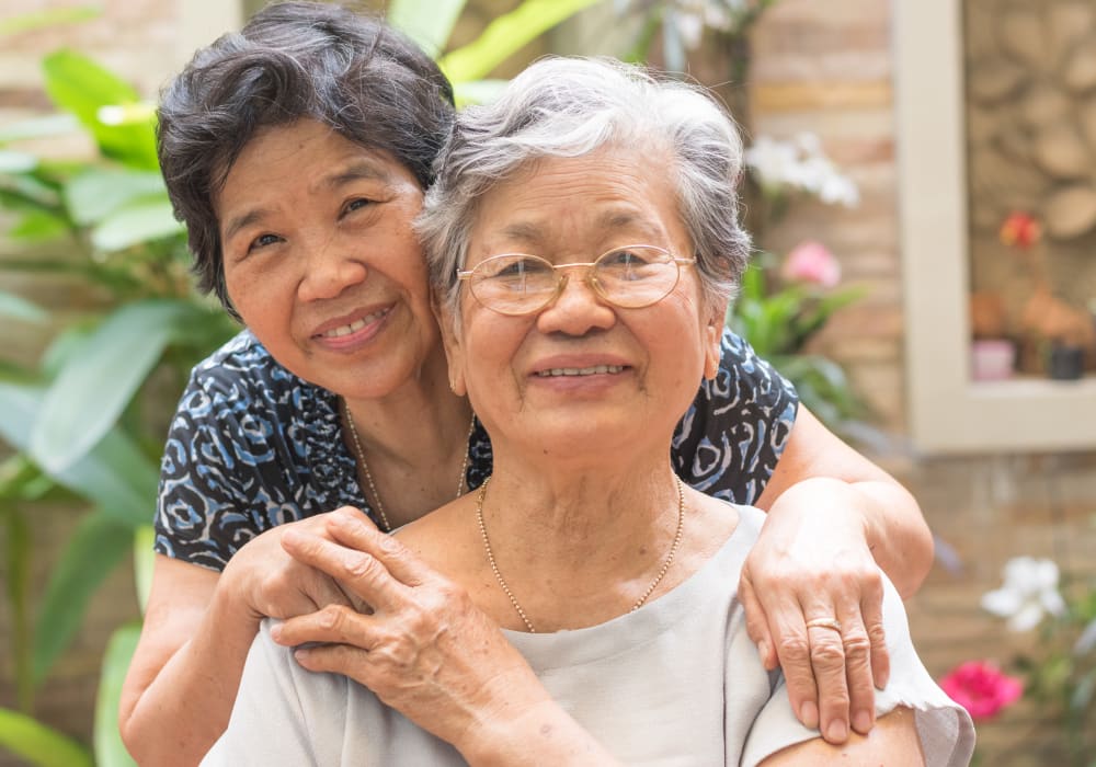 Resident friends hugging at Holden Southcenter in Tukwila, Washington. 