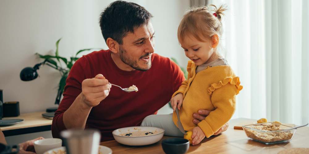 Resident feeding his daughter at The Bayou District in Gulfport, Mississippi