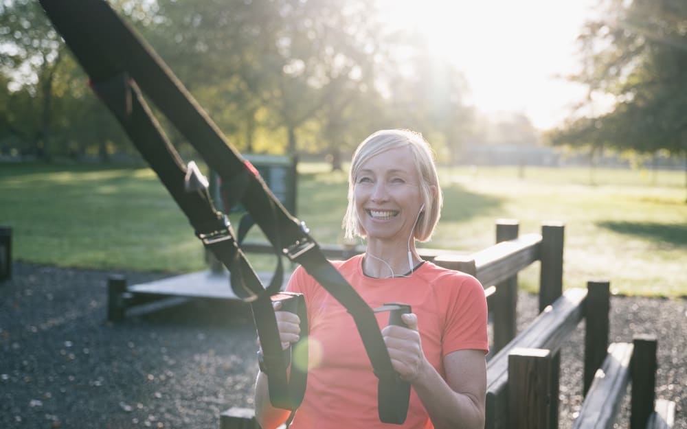 Resident starting her day with a workout in an outdoor fitness park near Top Field Apartment Homes in Cockeysville, Maryland