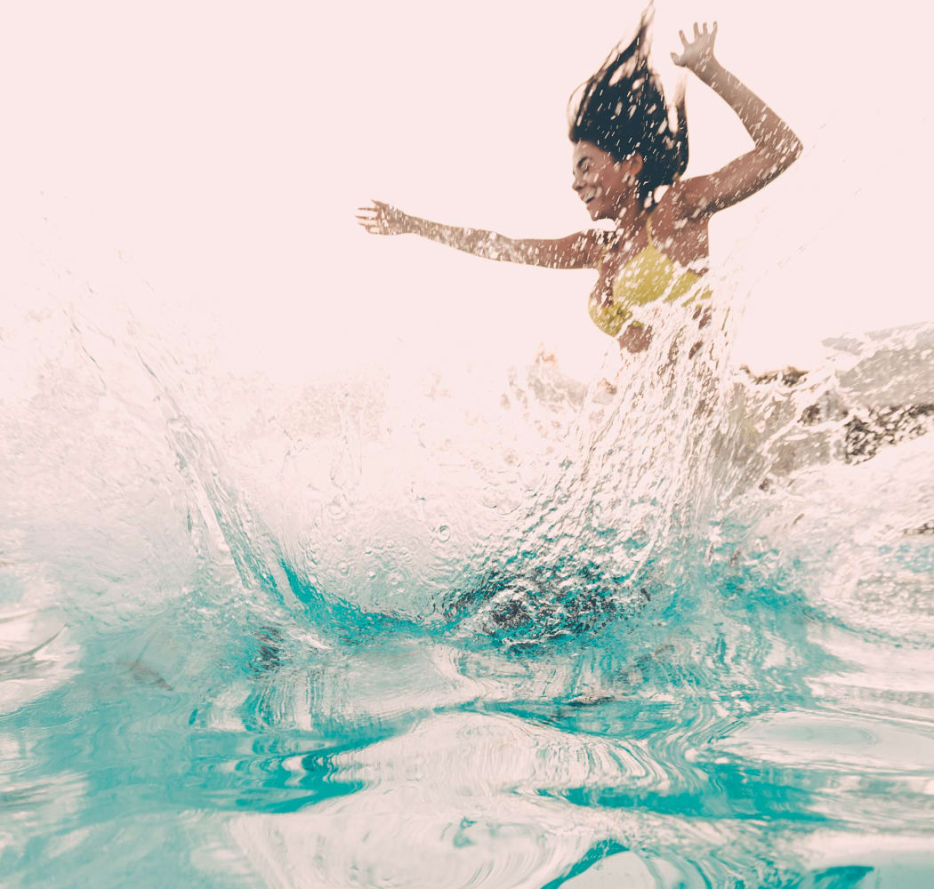 Woman jumping into the pool at Fox Run Apartments in Wichita, Kansas