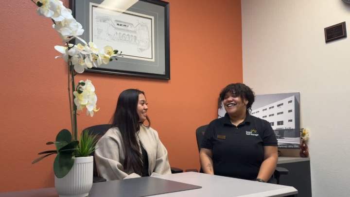 Janell, podcast host, is sharing a laugh with Assistant Manager, Marisa, of Arroyo Parkway Self Storage. 