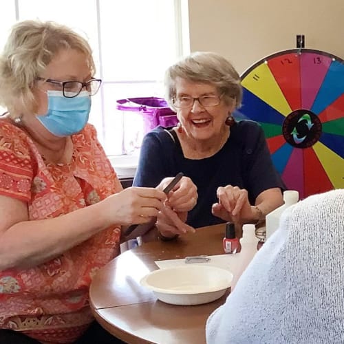 Resident and caretakers with masks at Canoe Brook Assisted Living in Wichita, Kansas