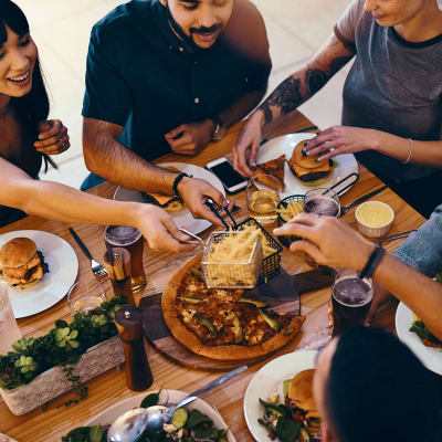 Friends sharing a meal together near Claremont Towers in Hillsborough, New Jersey