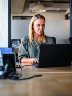 A women on her computer at her job near Harborside Marina Bay Apartments in Marina del Rey, California