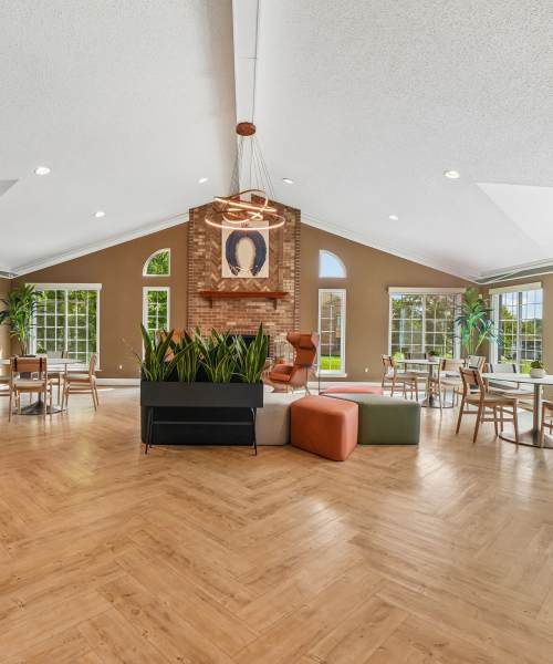 Clubhouse with a fireplace and well-appointed kitchen at Saddle Creek Apartments in Novi, Michigan