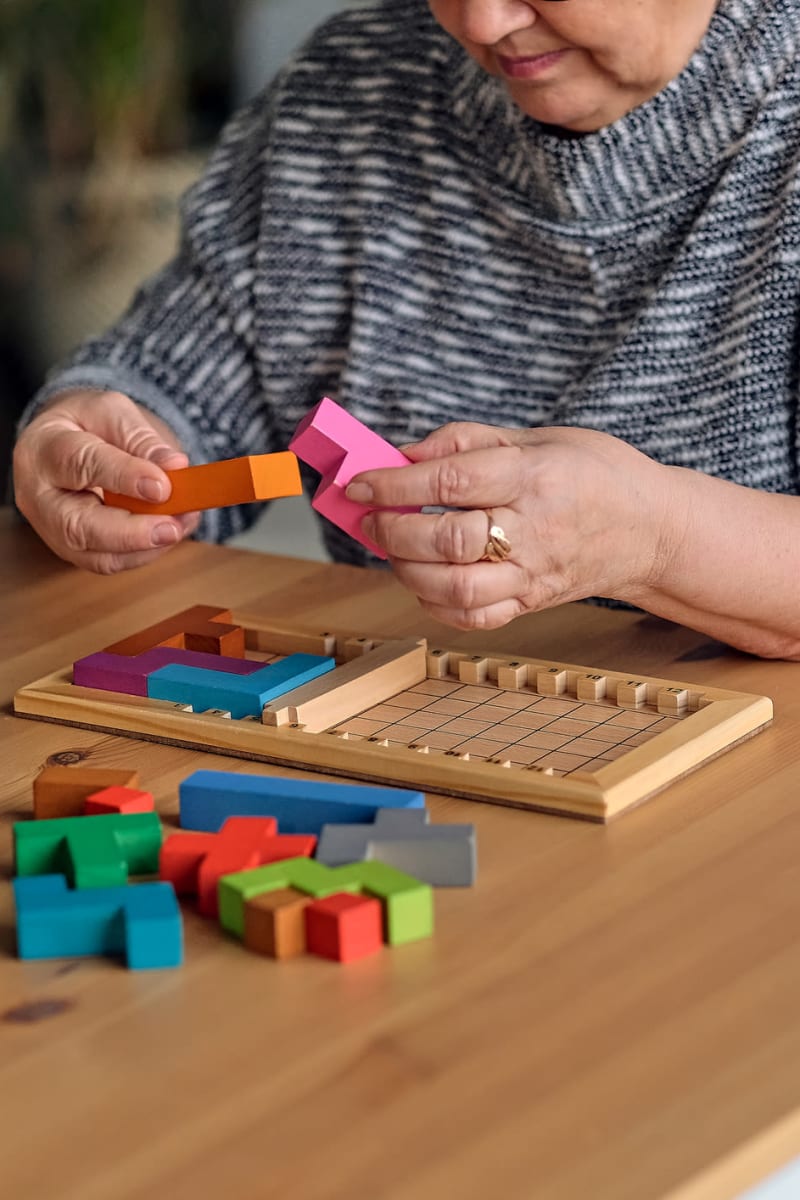 Resident using puzzle blocks at Trustwell Living of Overland Park in Overland Park, Kansas