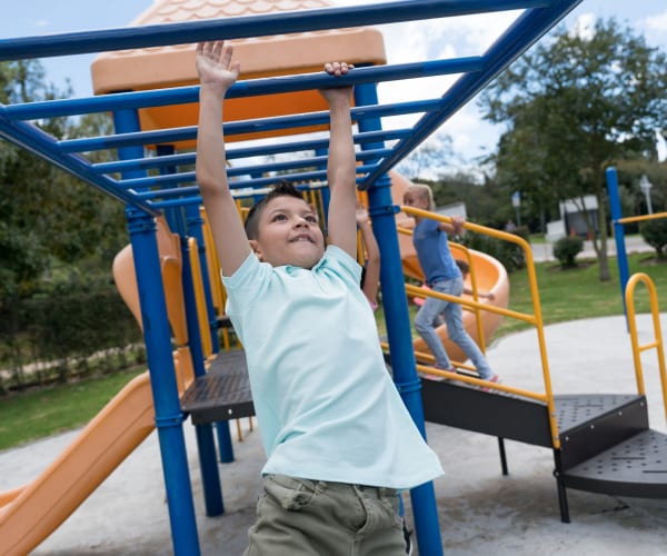 A child playing at a playground at Naval Amphibious Base in San Diego, California