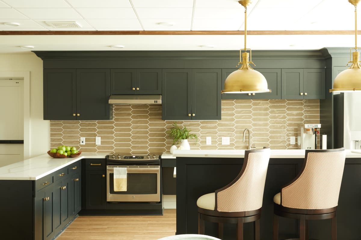 Community demonstration kitchen with a custom subway tile backsplash and bar seating at Amira Roseville in Roseville, Minnesota