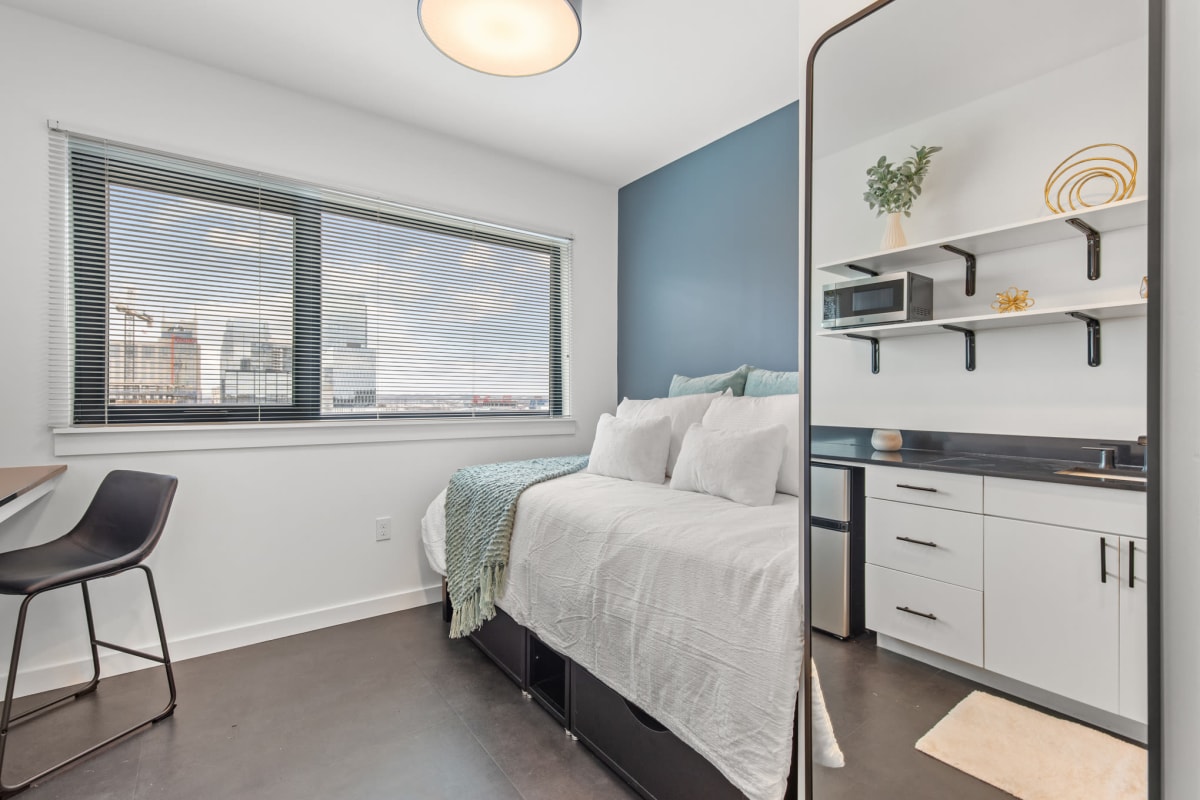 Bed and a changing mirror in a model apartment at Rutledge Flats in Nashville, Tennessee