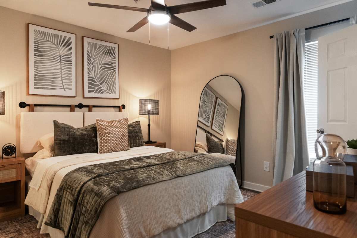 Model bedroom with ceiling fan at The Landings at Houston Levee in Cordova, Tennessee