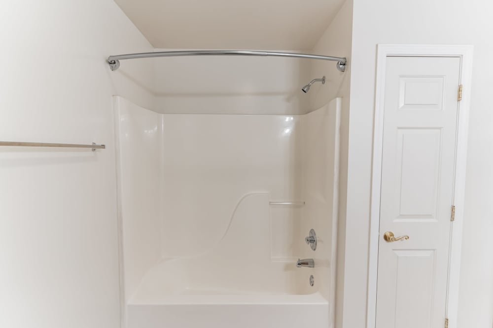 Shower and extra storage in a model home's bathroom at Eagle Rock Apartments & Townhomes at Rensselaer in Rensselaer, New York