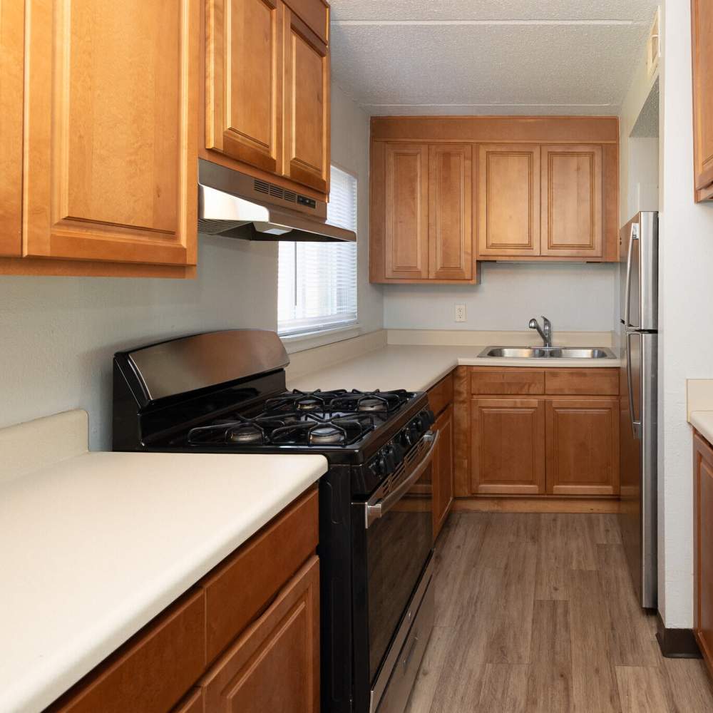 Kitchen with storage and black appliances at Monaco Arms in Jacksonville, Florida